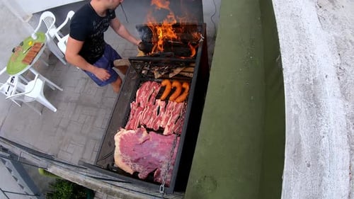 Time Lapse of a white man making roast (asado) on grill on a sunny day outside barbecue