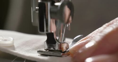 Sewing Machine Needle Piercing Through Fabric