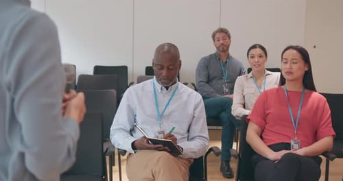 Diverse Group Listening to Speaker at Conference