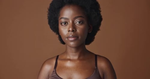 Face of black woman, afro model or natural beauty for wellness, cosmetics or healthy skin in studio