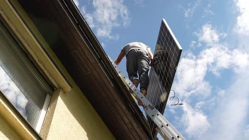 PV professional techincian climbing lather to install high-end solar panel