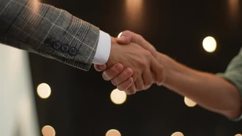View From Interior of the Car to Unrecognizable Salesman and Happy Customer Shaking Hand in Auto