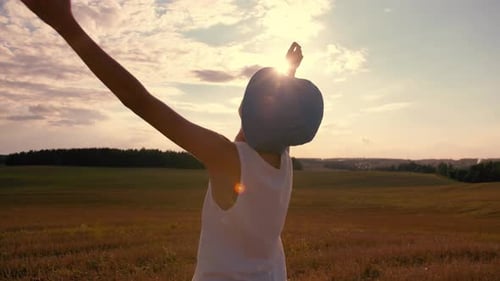 Child Enjoying Sunset in a Golden Field