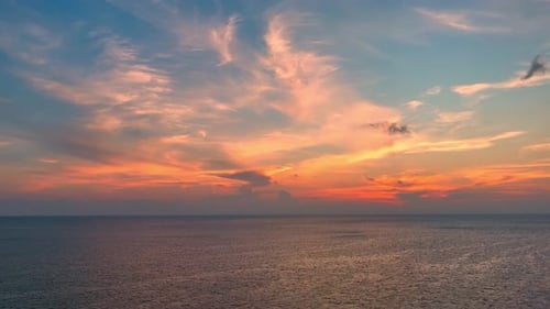 Drone aerial view of endless horizon over the sea in golden sunset. 4K.