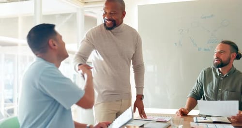 Three Men Celebrating Business Success in Modern Office