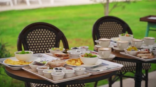 European Breakfast Buffet Served on Restaurant Patio Assorted Dishes Include Eggs Bread Coffee Salad