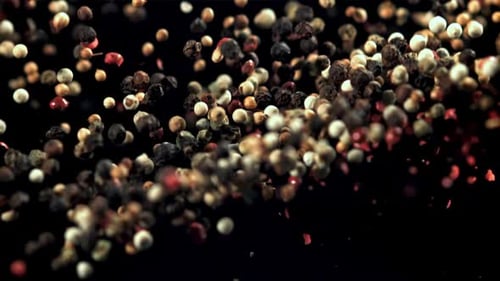 Assorted Peppercorns Floating on Dark Background