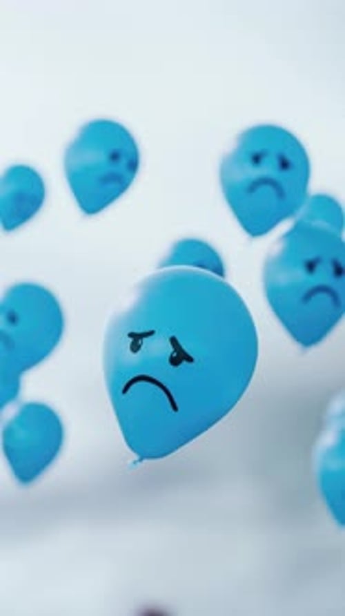 Blue balloons with sad faces float through a grey sky, symbolizing the gloom for Blue Monay