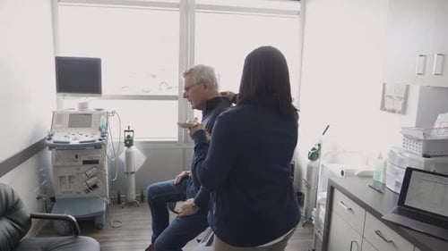 Female Doctor with Spine Model Explaining Injury to Patient in Clinic 4044 Years