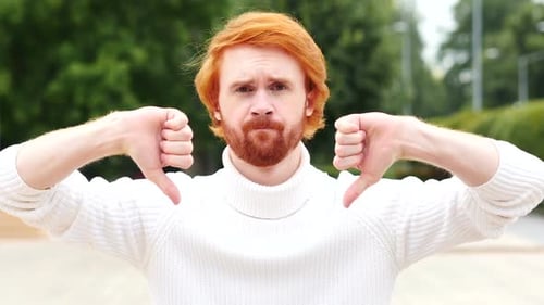 Man Showing Thumbs Down in Urban Environment