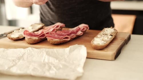 Assembling Salami and Cream Cheese Baguette Sandwiches