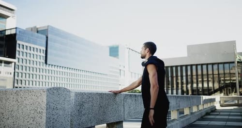 Man Stretching Outdoors in an Urban Setting