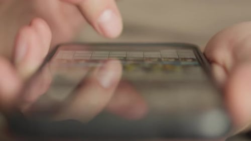 Finger Scrolls on Phone Screen, Close Up