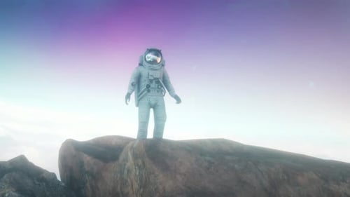 A man in a space suit stands on a rocky hill. Futuristic or space travel backgrounds