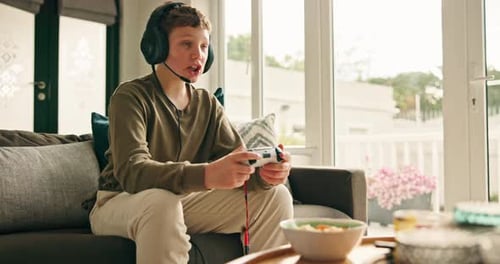 Teen Boy Gaming at Home with Headphones