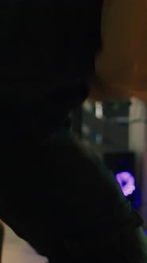 Young Adult Coding in Urban Office at Night