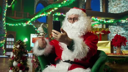 Santa Claus Entertaining Children During Phone Videocall