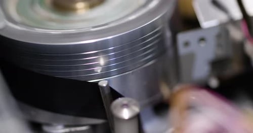 Tight close-up shot of a vintage VHS tape recorder - play starts rolls put tape on the spinning head