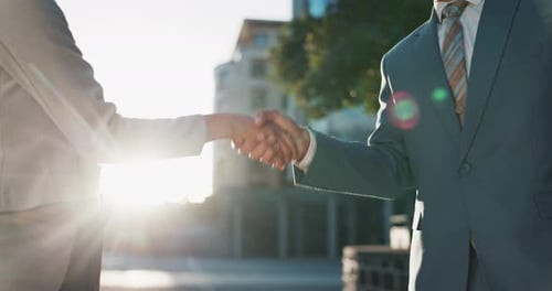Business Professionals Handshake on Bright City Street
