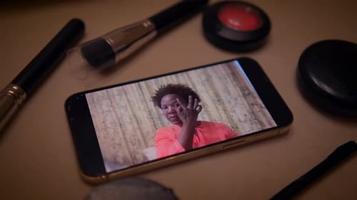 Woman in Makeup Tutorial on Cellphone Close Up