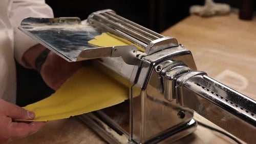 Pasta Dough Running Through Pasta Machine