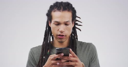 Young Adult Smiles While Using Mobile Phone