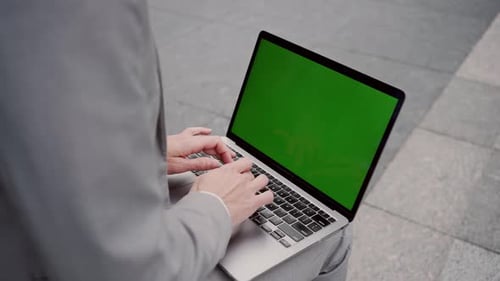 Close Up of Woman Typing on Laptop with Chroma Key Screen