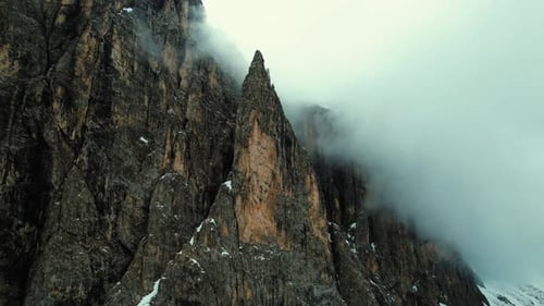 4k Drone Upward Tilt Shot Of Jagged Sharp Rock Peak Of Dolomite Mountains In Northern Italy