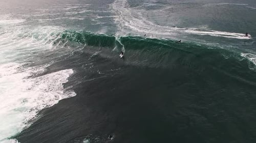 Surfers Riding Giant Waves in the Ocean
