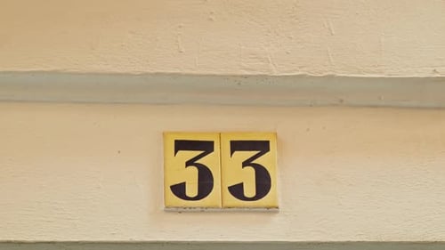 Number 33 (thirty-three) Affixed to a Building