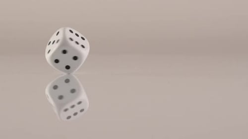 Spinning White Dice with Black Dots on Beige