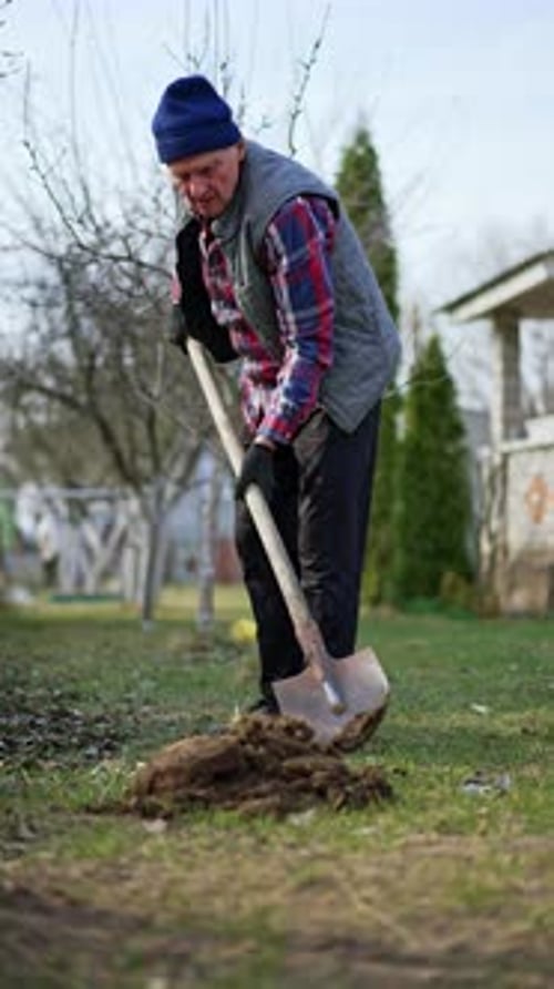 Man Gardening With Shovel in Rural Environment
