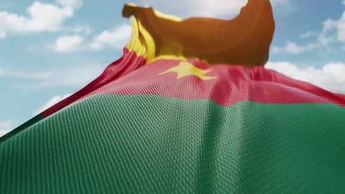 Realistic Waving Flag Of Burkina Faso Against Blue Sky