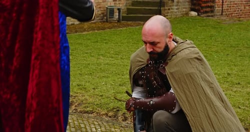 Medieval Knight Being Knighted by King Outdoors
