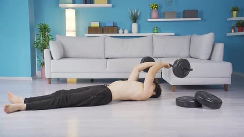 Man Lifts Barbell During Floor Workout in Apartment