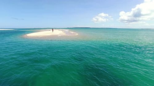 Aerial Drone Quadcopter of Young Woman Walking on Beach With