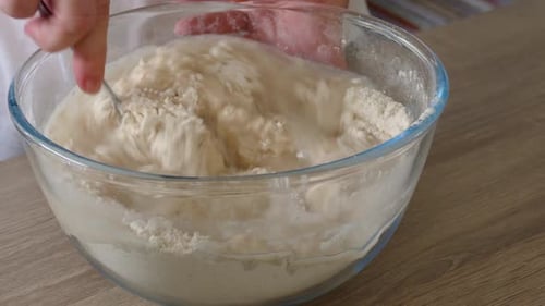 FEMALE HANDS KNEADING BREAD
