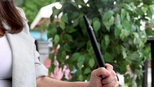 girl woman smoking hookah in terrace restaurant sitting with coffee cup on table,typing message