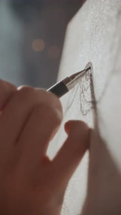 Close Up of Artists Hand Drawing Eye Detail with Pencil on Canvas
