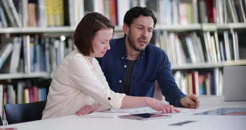 Mature students in library studying together
