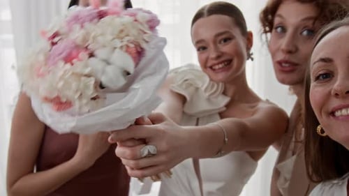 Bridesmaids Recording Video with Bride before Wedding Ceremony