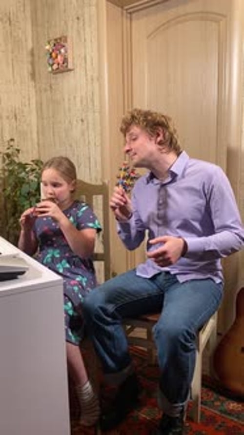 Girl and Man Play Musical Instruments Together