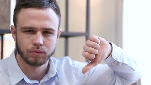Thumbs Down By Young Man