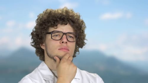 Young Adult with Curly Hair Thinking Closely