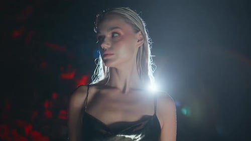 Elegant Woman with Wet Hair Posing in Dark