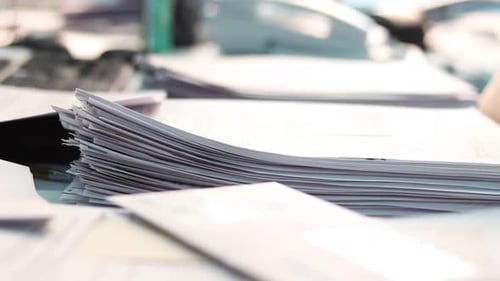 White Documents on a Desk in the Office