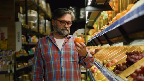 Senior Man Selecting Fresh Fruits at Grocery Store