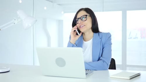 Smiling Woman Working, Talking on Phone in Office