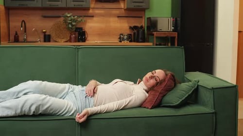 Tired Young Sleepy Brunette Woman Falls on the Sofa A Carefree Girl is Napping Falling Asleep on a