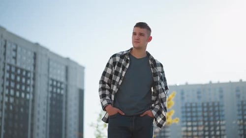 Young Man Walking in Urban Setting